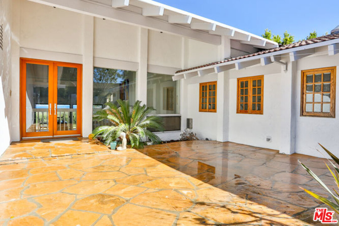 7050 Dume Drive Malibu, CA 90265 - Photo 6 of 13 a view of a house with wooden floor and potted plants