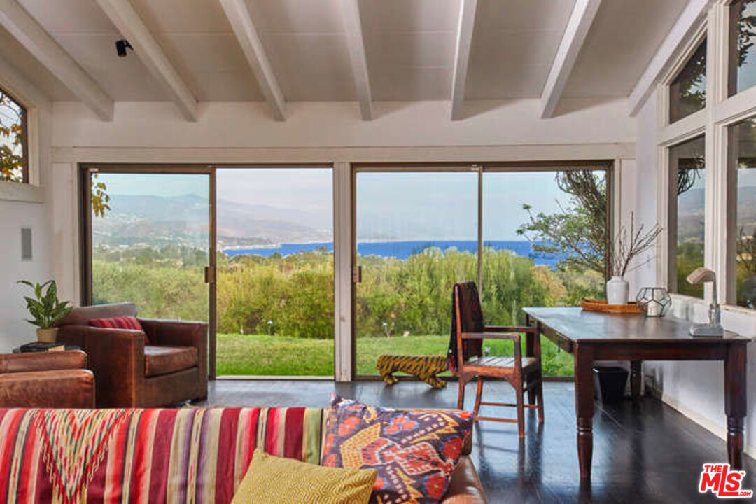7050 Dume Drive Malibu, CA 90265 - Photo 7 of 13 a living room with furniture and a floor to ceiling window