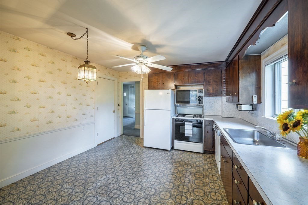 72 Rice Street, Unit 72 Cambridge, MA 02140 - Photo 3 of 20 a kitchen with stainless steel appliances granite countertop a sink a stove and a refrigerator