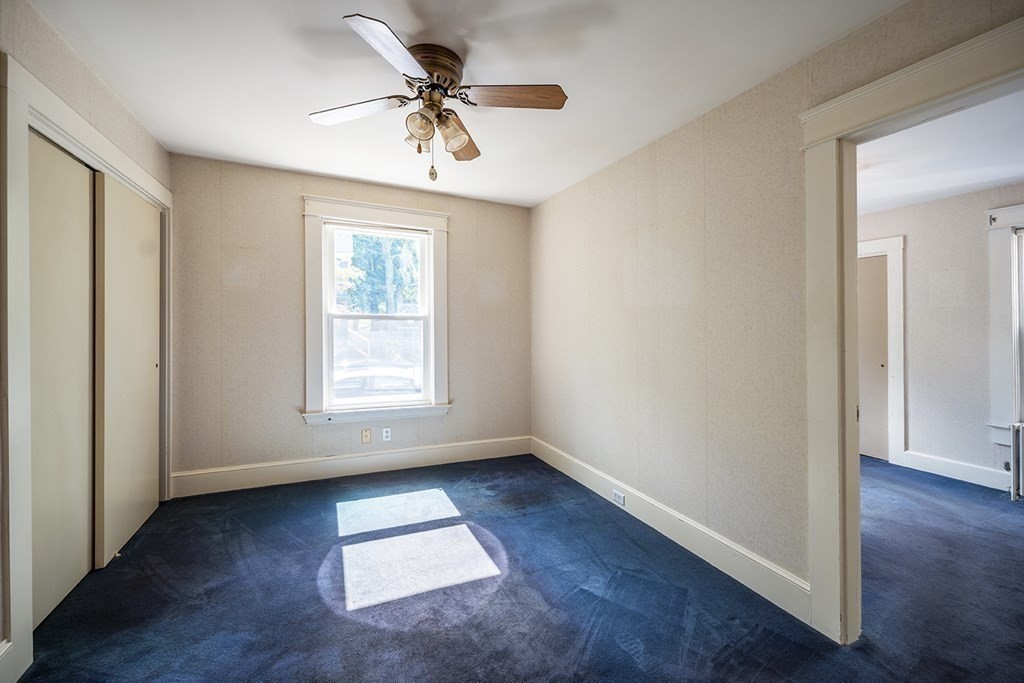 72 Rice Street, Unit 72 Cambridge, MA 02140 - Photo 9 of 20 wooden floor in an empty room with a window