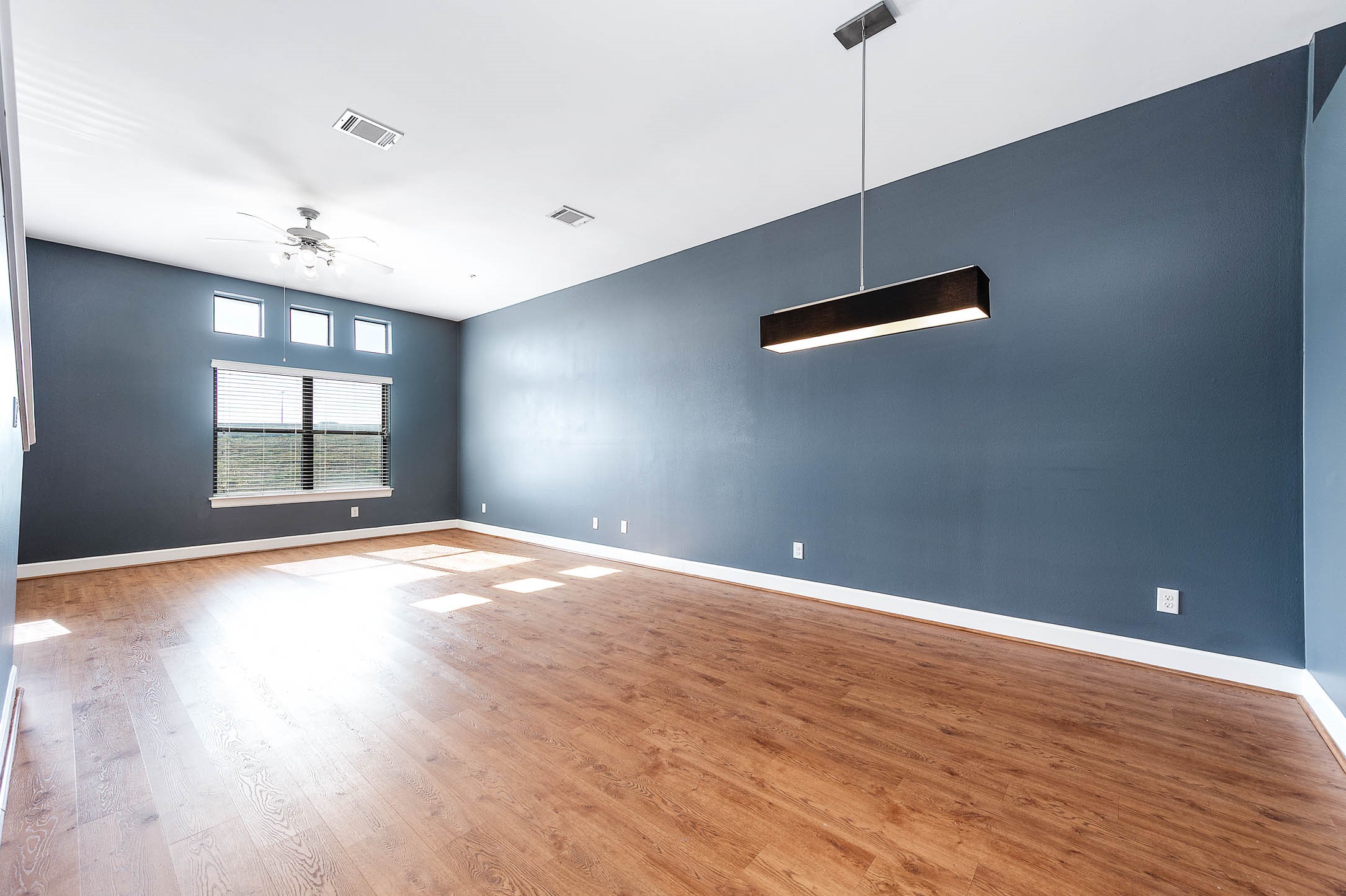 7650 Springhill Street, Unit 704 Houston, TX 77021 - Photo 5 of 23 a view of empty room with wooden floor and fan