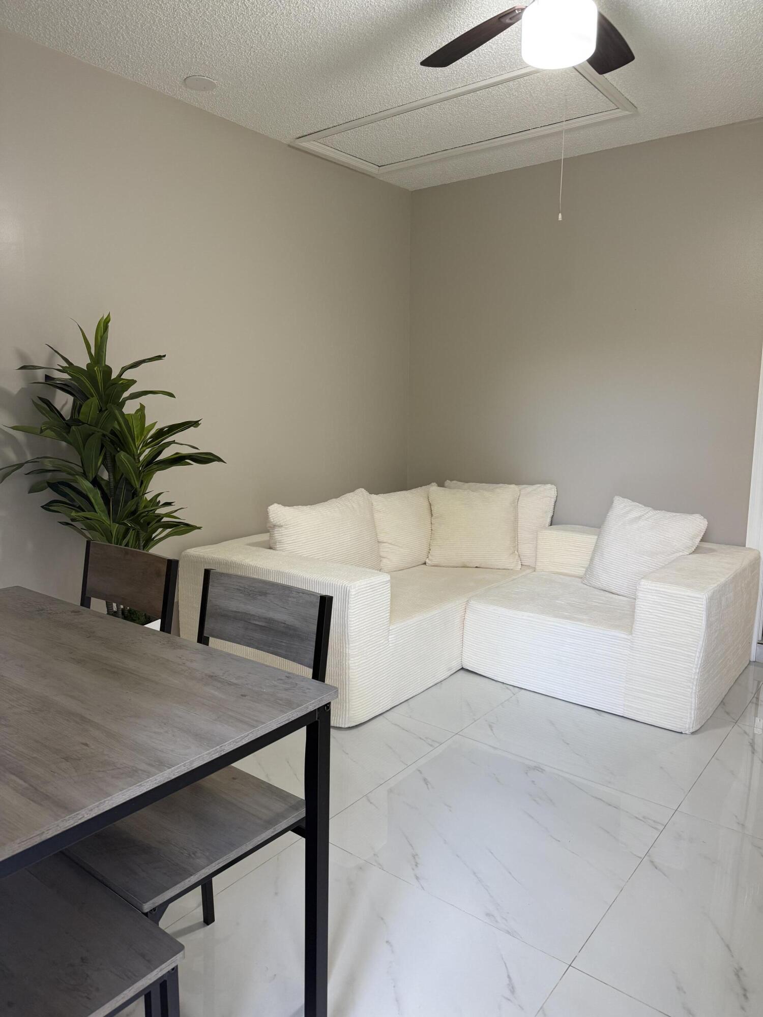 14523 Flamingo Road Loxahatchee Groves, FL 33470 - Photo 45 of 50 a living room with furniture and a potted plant