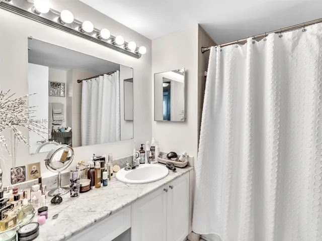 a bathroom with a double vanity sink and a mirror