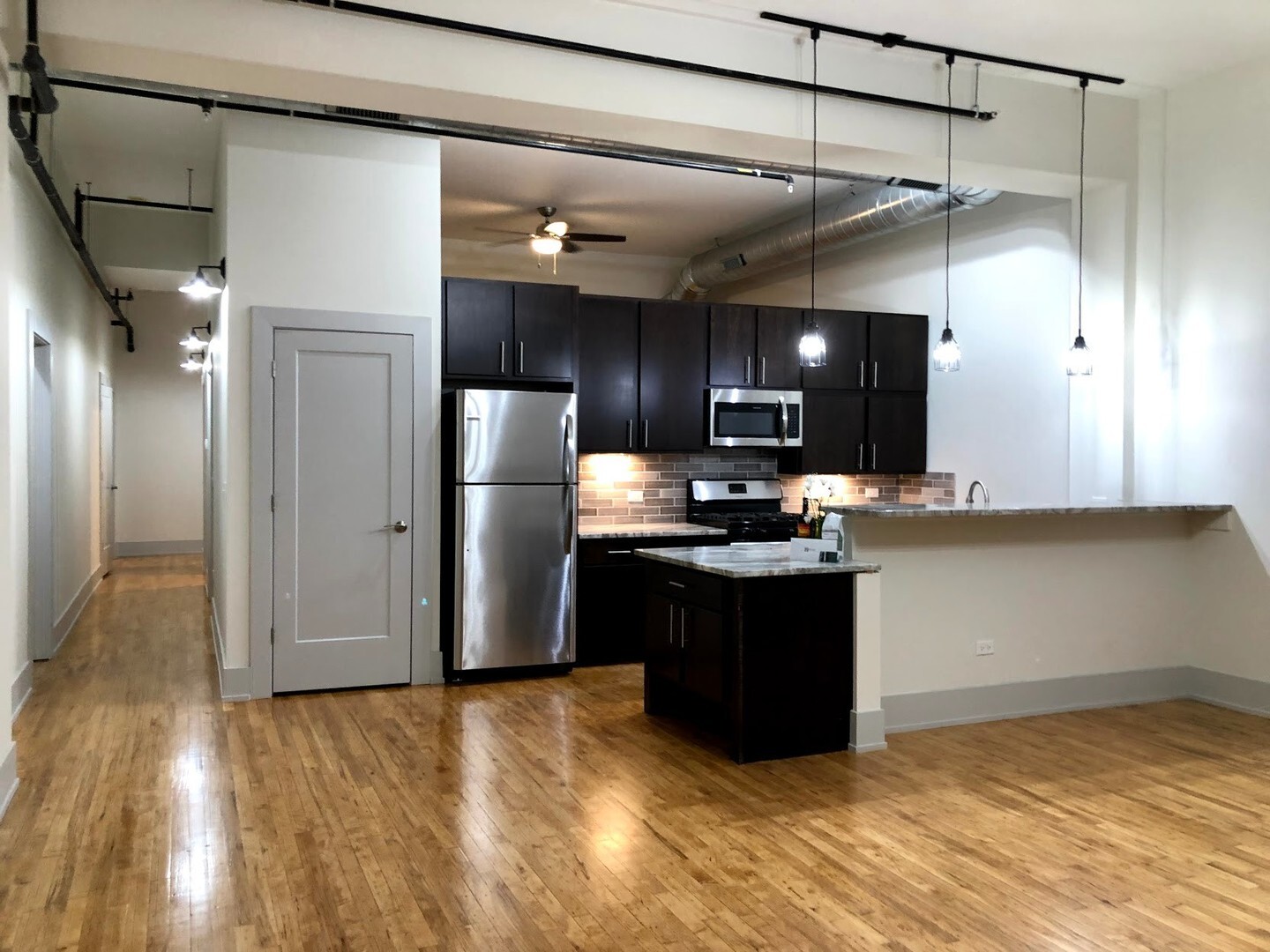 1432 West 21st Street, Unit 306 Chicago, IL 60608 - Photo 2 of 9 a kitchen with stainless steel appliances granite countertop a refrigerator and a sink