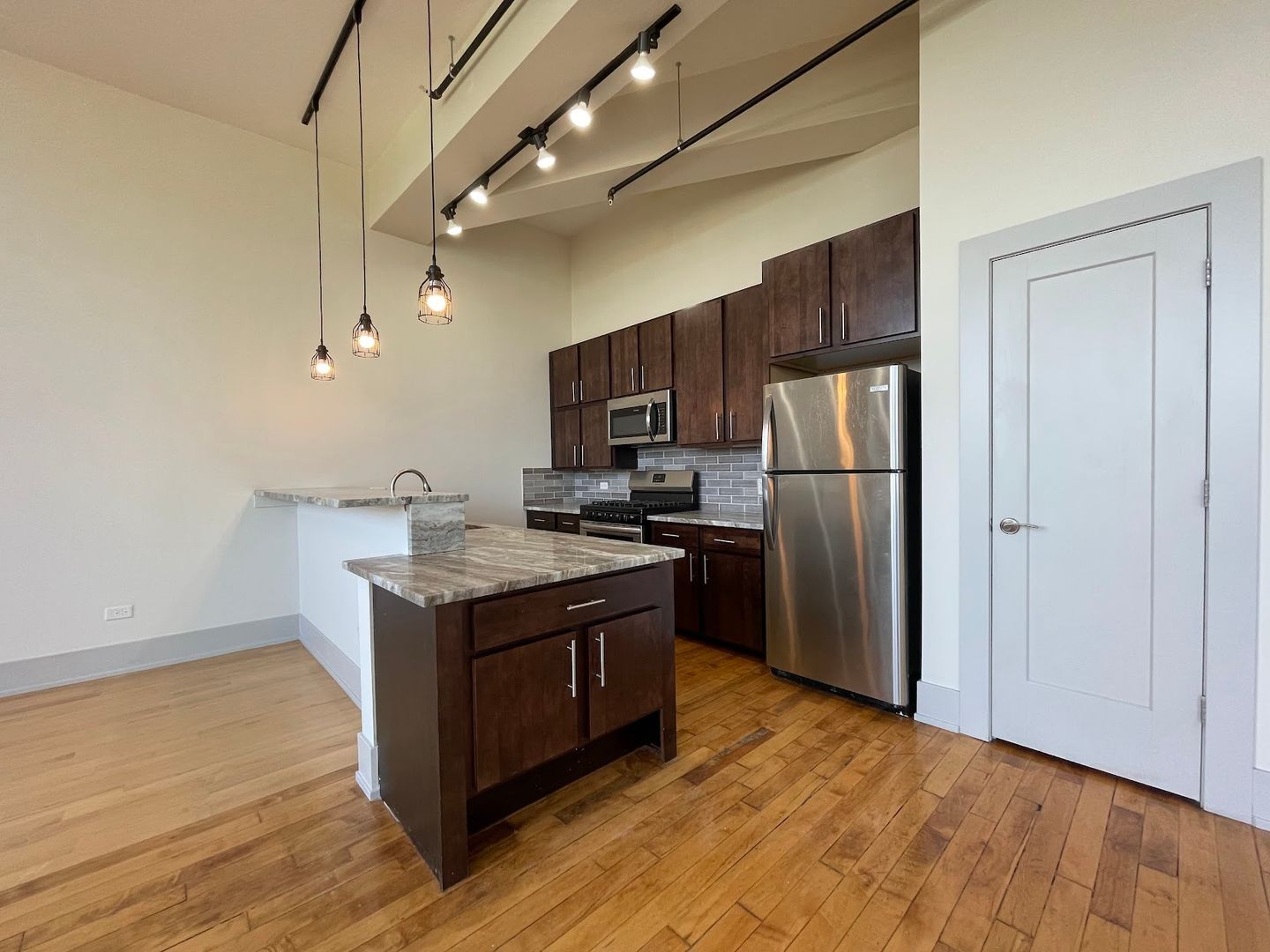 1432 West 21st Street, Unit 306 Chicago, IL 60608 - Photo 8 of 9 a kitchen with stainless steel appliances granite countertop a stove a refrigerator and a microwave
