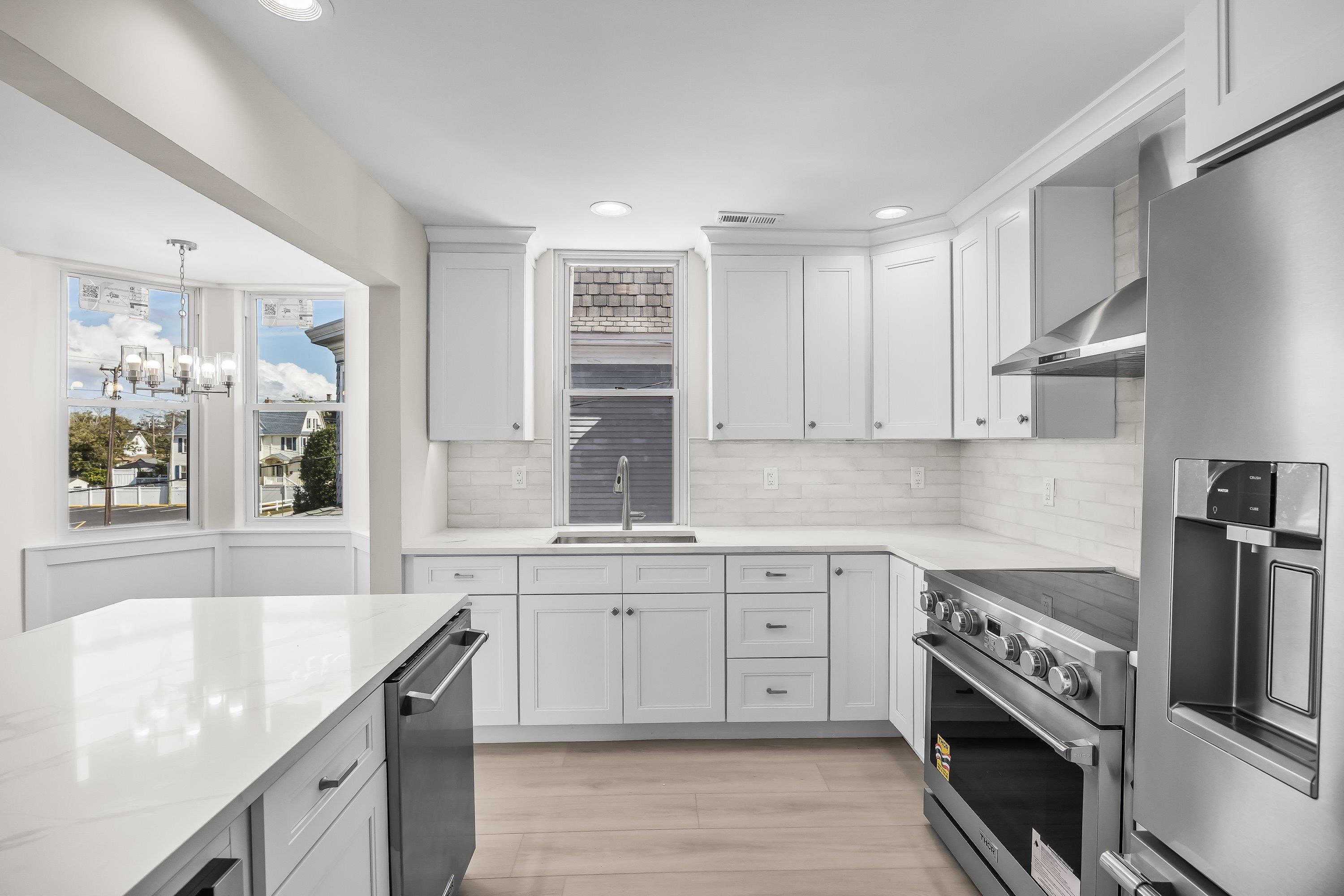 733 Wesley Road, Unit NORTH Ocean City, NJ 08226 - Photo 16 of 47 a kitchen with a sink stove and cabinets
