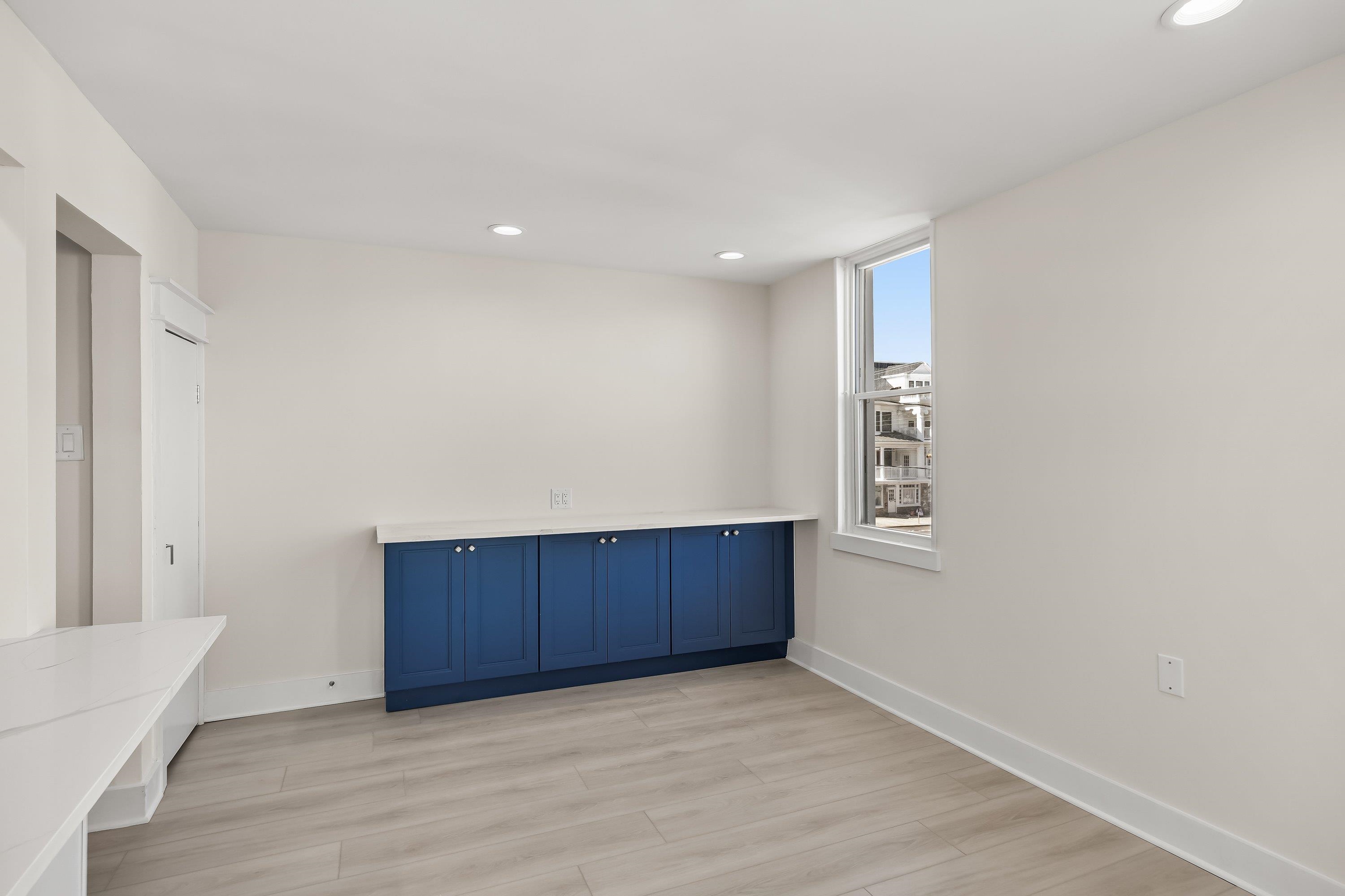 733 Wesley Road, Unit NORTH Ocean City, NJ 08226 - Photo 18 of 47 a view of an empty room with wooden floor and a cabinet