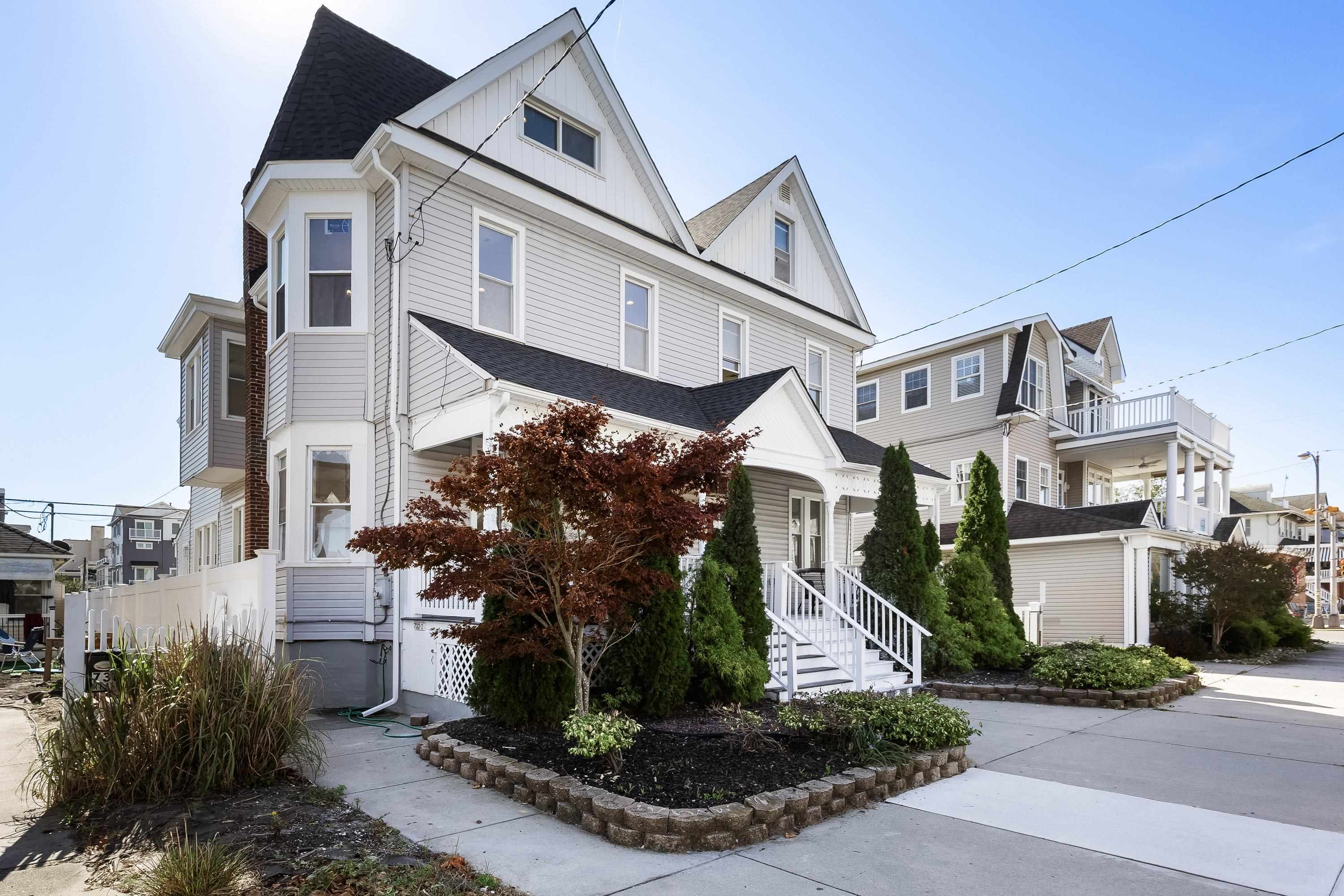 733 Wesley Road, Unit NORTH Ocean City, NJ 08226 - Photo 2 of 47 a view of a white building among the street with palm trees