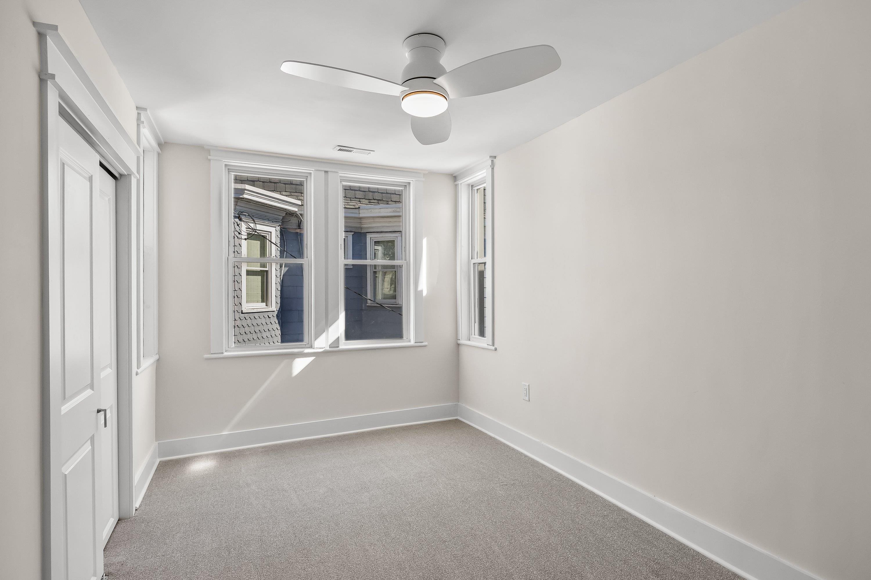 733 Wesley Road, Unit NORTH Ocean City, NJ 08226 - Photo 21 of 47 an empty room with windows and fan