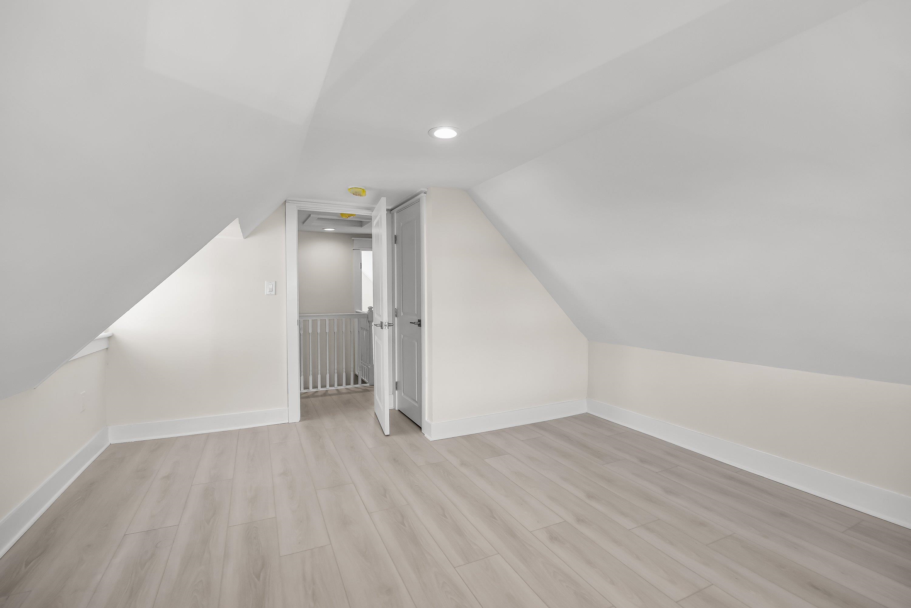 733 Wesley Road, Unit NORTH Ocean City, NJ 08226 - Photo 27 of 47 an empty room with wooden floor and white walls