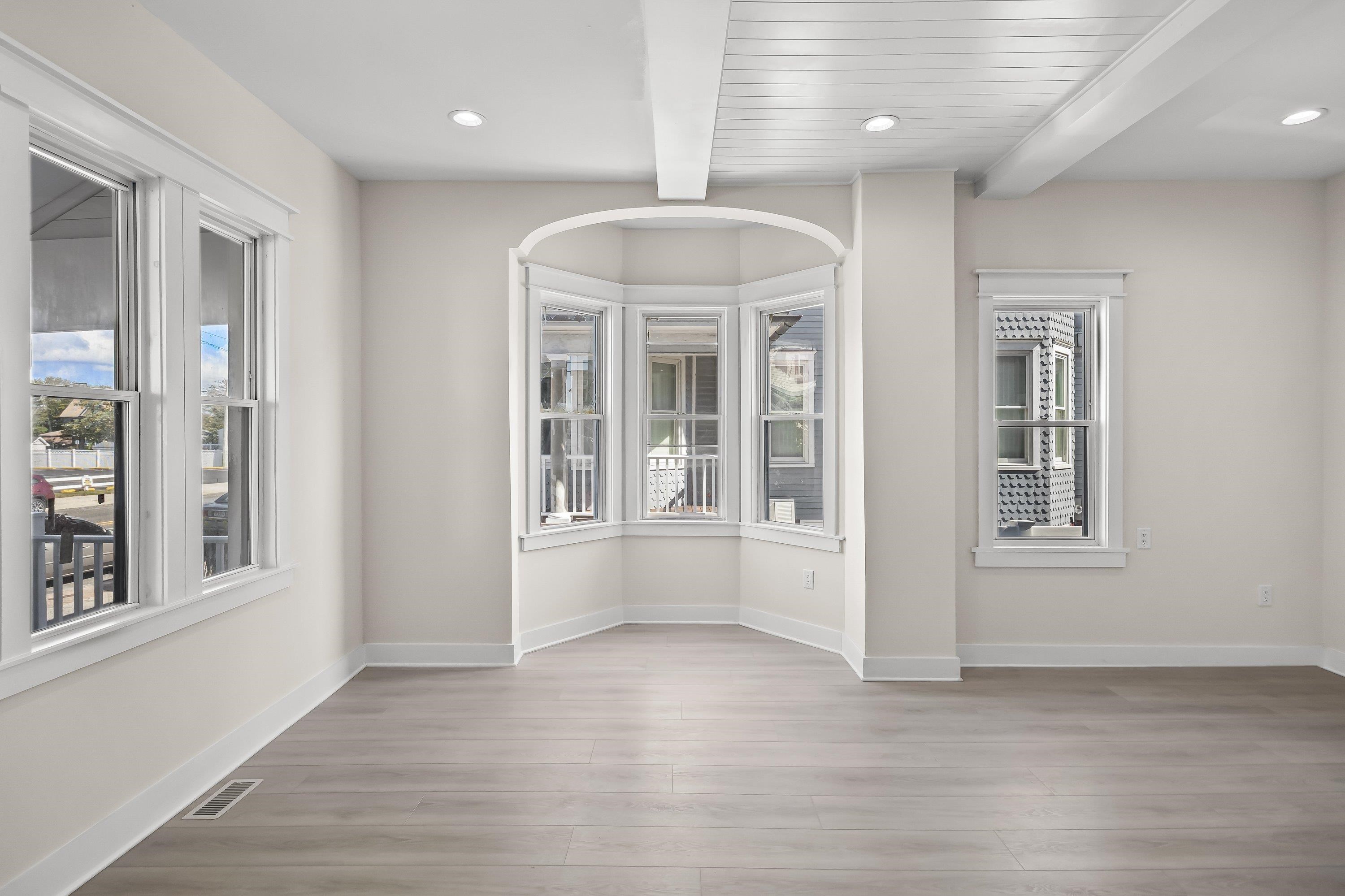 733 Wesley Road, Unit NORTH Ocean City, NJ 08226 - Photo 6 of 47 an empty room with wooden floor and windows