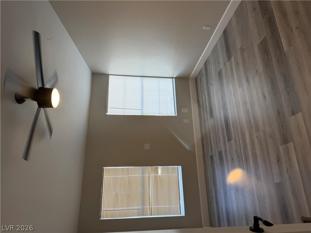 6041 Hafen Ranch Road Pahrump, NV 89061 - Photo 6 of 12 High ceilings complement light wood-like flooring, enhancing the spaciousness of this open living area.