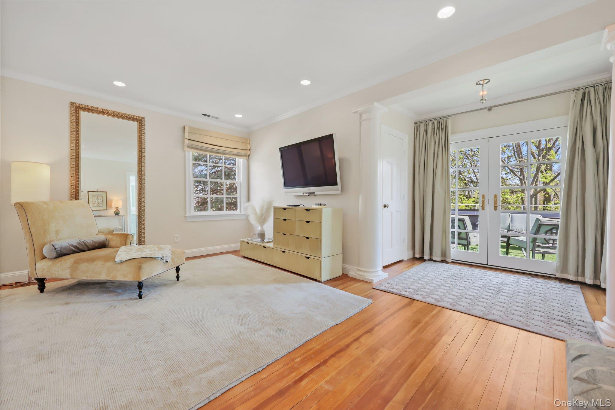 7 Plateau Circle West Bronxville, NY 10708 - Photo 19 of 34 a spacious bedroom with a bed a couch and a flat tv screen on dresser