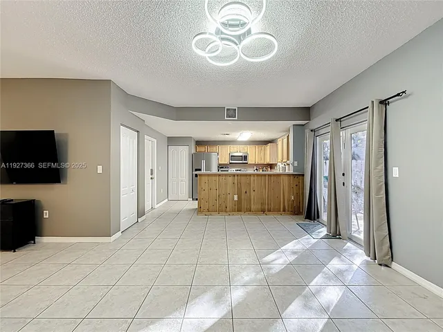 a view of a livingroom with furniture and a flat screen tv
