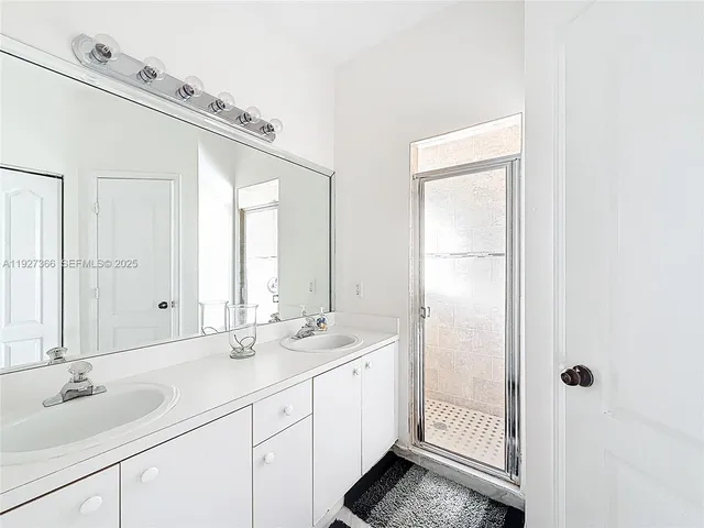 a bathroom with a double vanity sink and a mirror
