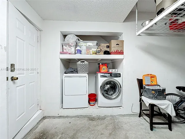 a utility room with sink dryer and washer