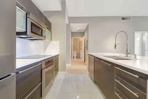 a view of wooden floor and windows in a room