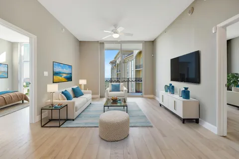 a large kitchen with kitchen island a sink a stove and a wooden floors