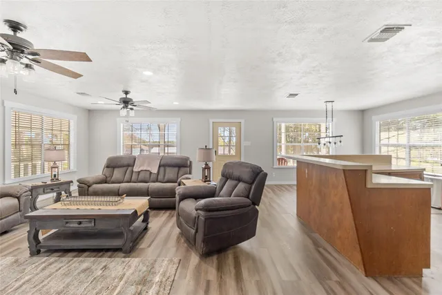 a living room with furniture and a wooden floor