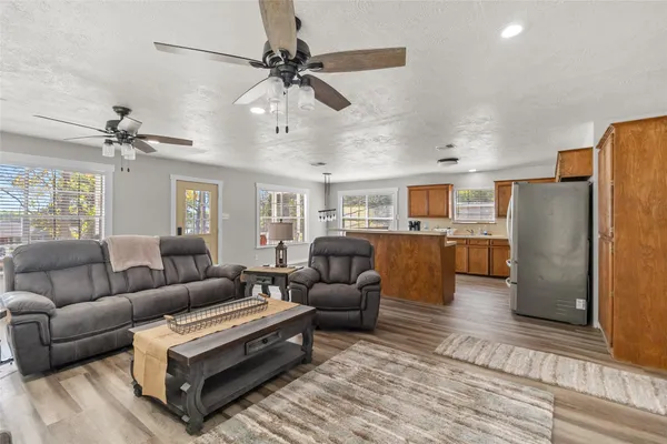 a living room with furniture and kitchen view