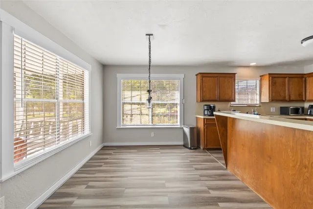 a view of kitchen with granite countertop window and a counter top space