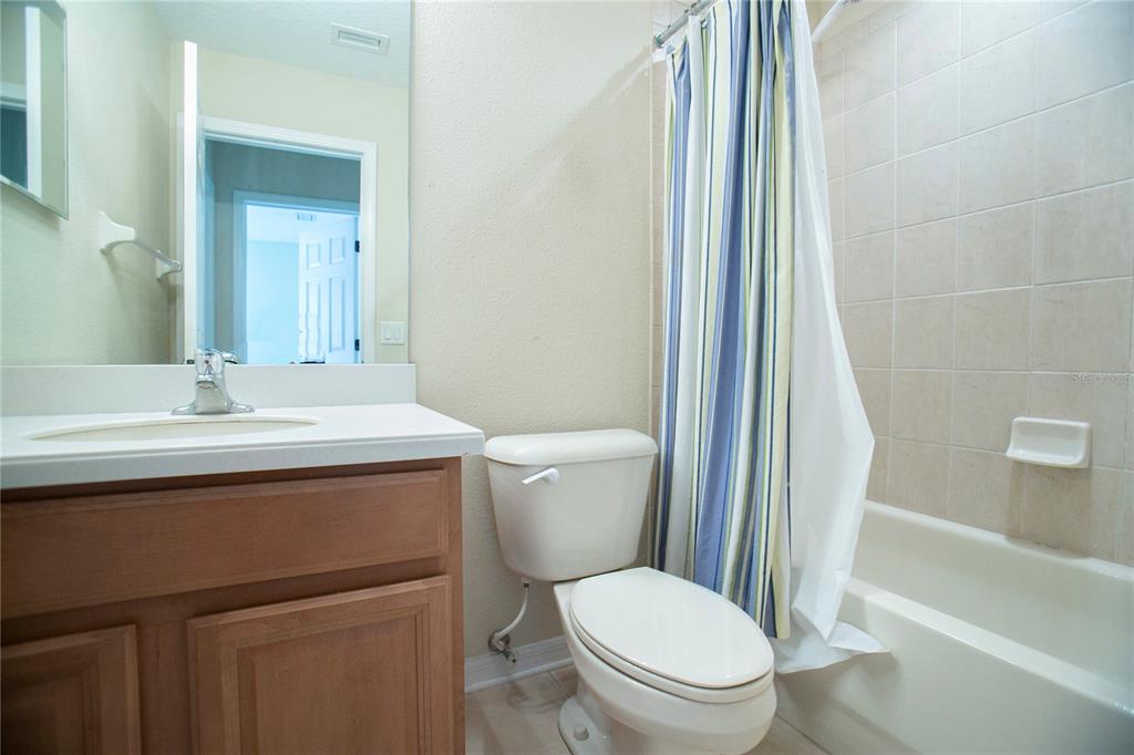 11919 Essington Street New Port Richey, FL 34654 - Photo 24 of 46 a bathroom with a sink toilet and shower