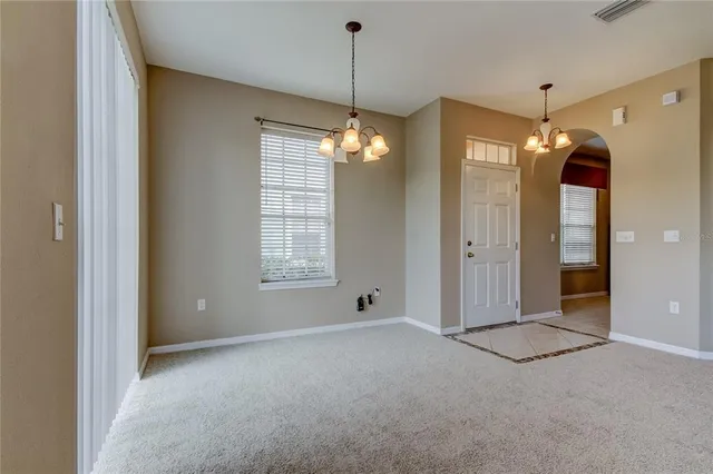a view of a room with window chandelier