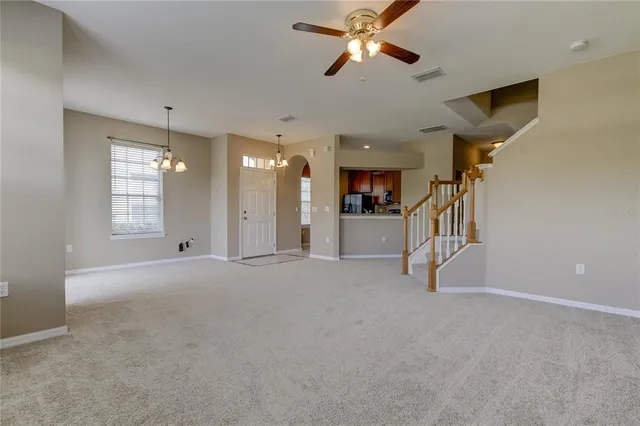 a view of a livingroom with a ceiling fan and window