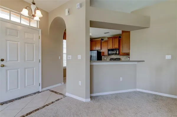 an empty room with windows and chandelier