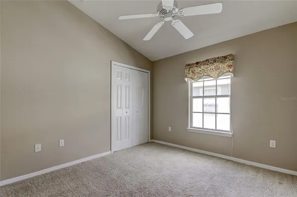 a view of an empty room with closet