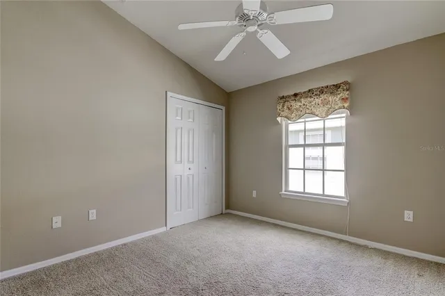 a view of an empty room with closet