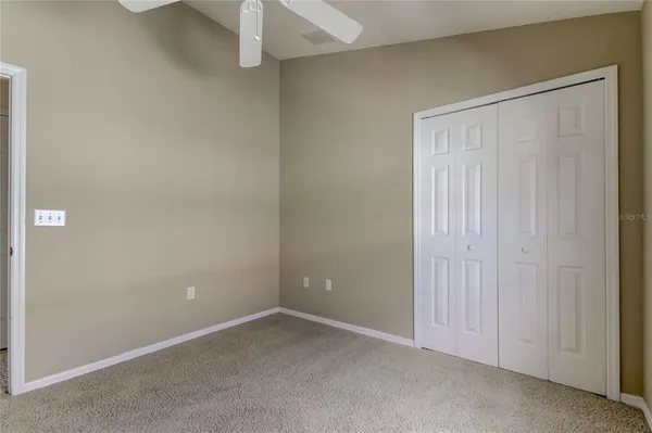 an empty room with a empty space and a ceiling fan