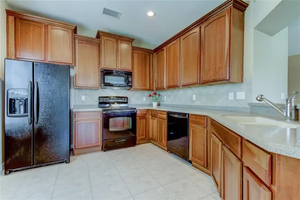 a kitchen with granite countertop stainless steel appliances and wooden cabinets