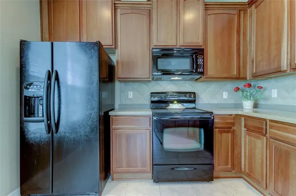 a kitchen with stainless steel appliances granite countertop a refrigerator stove and sink