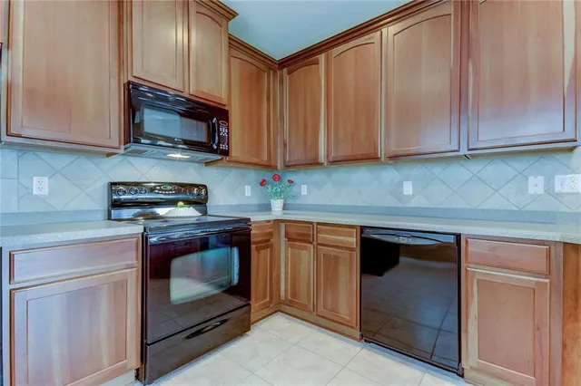 a kitchen with stainless steel appliances granite countertop a stove a microwave and a sink