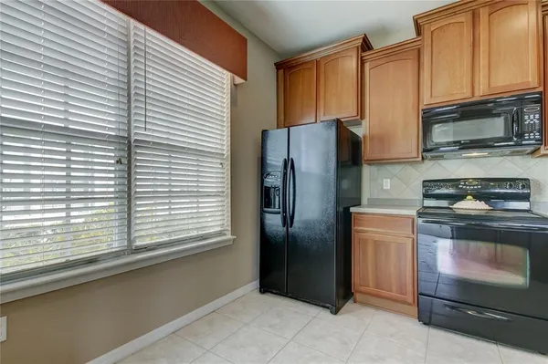 a kitchen with stainless steel appliances a refrigerator and a stove