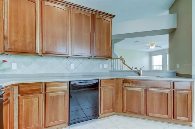a kitchen with granite countertop a sink and cabinets