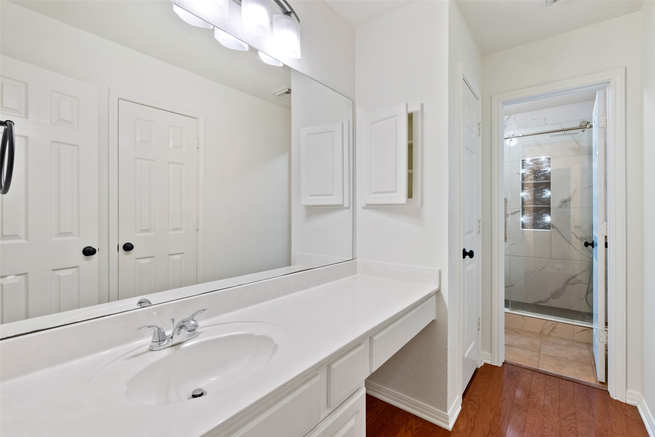 2950 Lantana Ridge Drive Austin, TX 78732 - Photo 17 of 40 a bathroom with a sink and a mirror