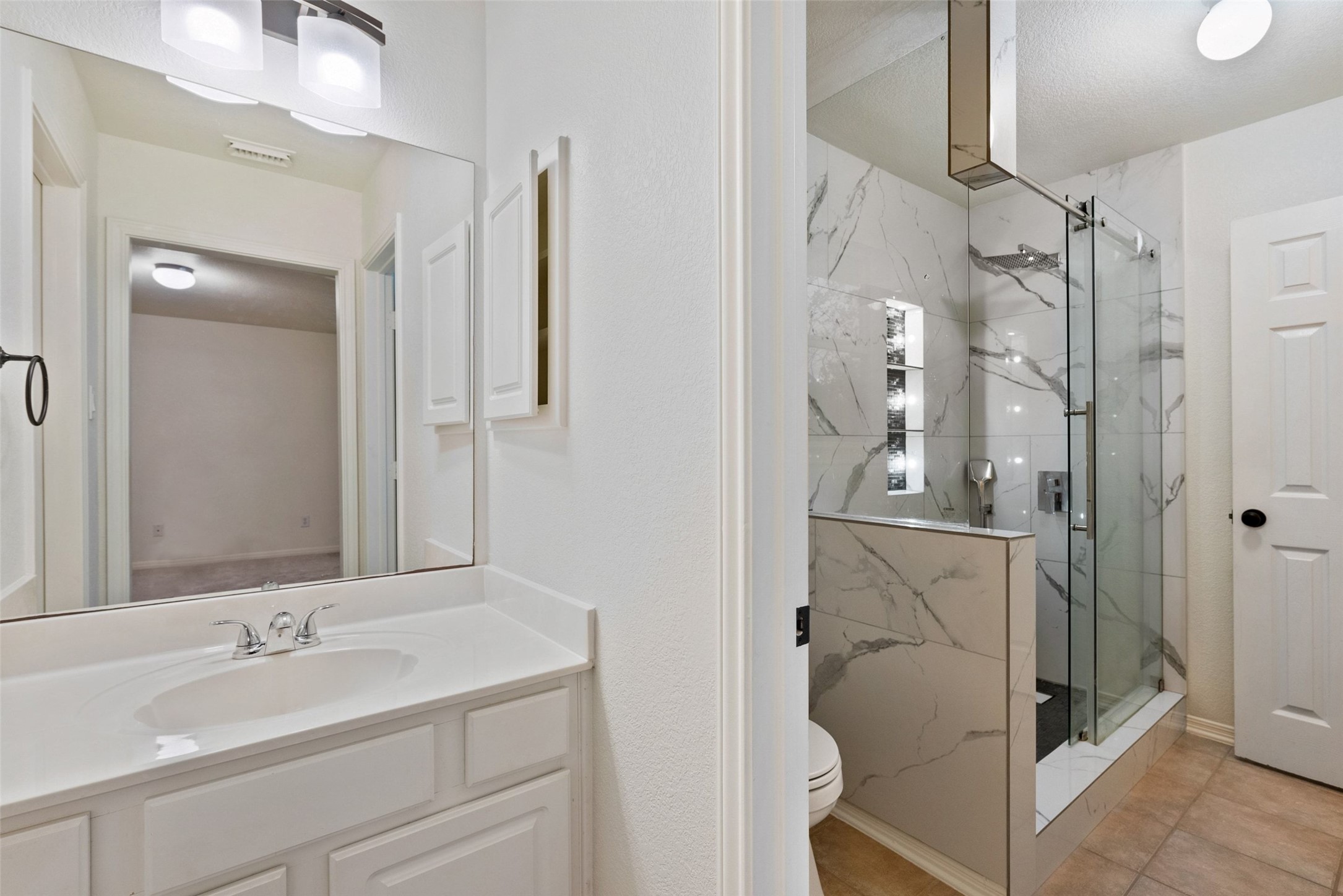 2950 Lantana Ridge Drive Austin, TX 78732 - Photo 19 of 40 a bathroom with a double vanity sink mirror and shower