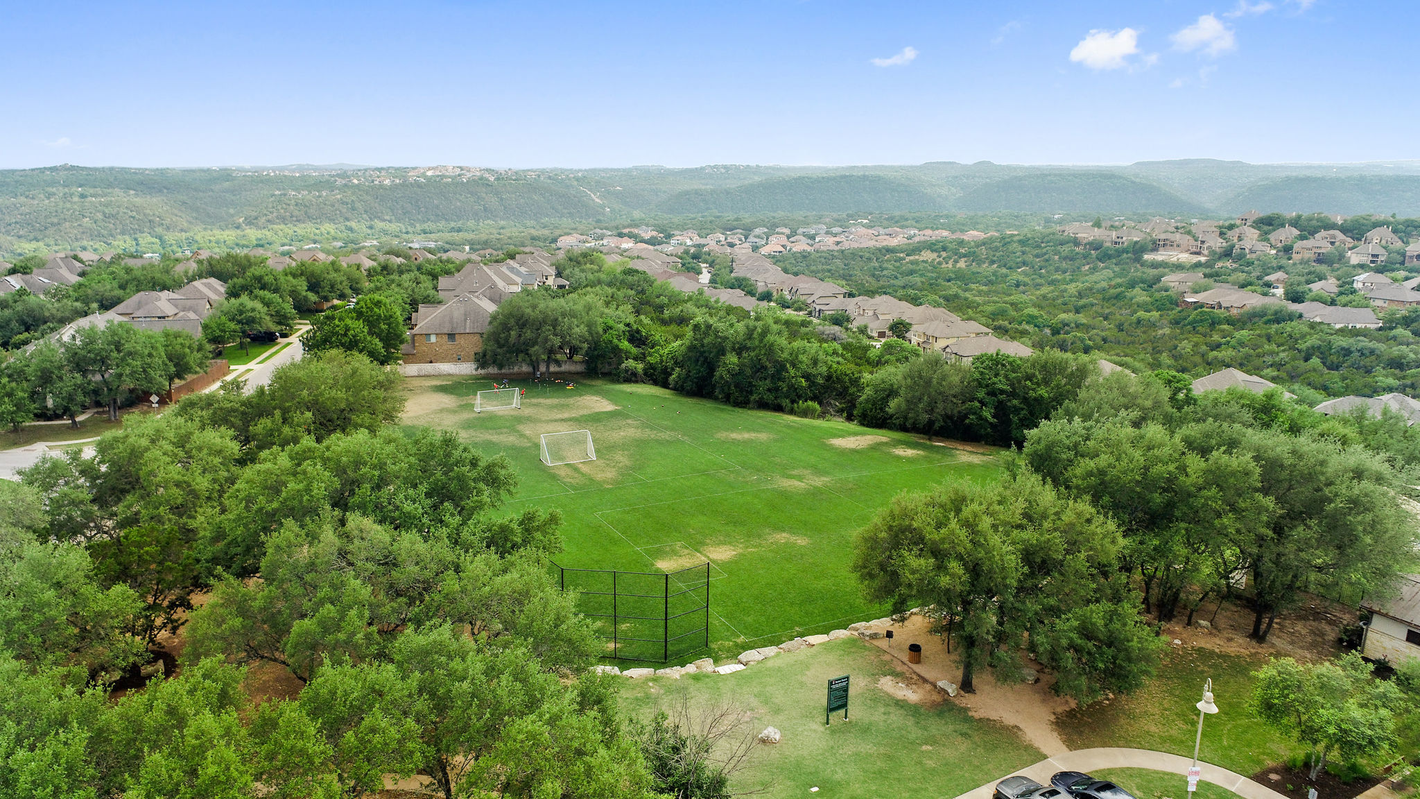 2950 Lantana Ridge Drive Austin, TX 78732 - Photo 28 of 40 a view of a lush green outdoor space with a lake view and mountain view