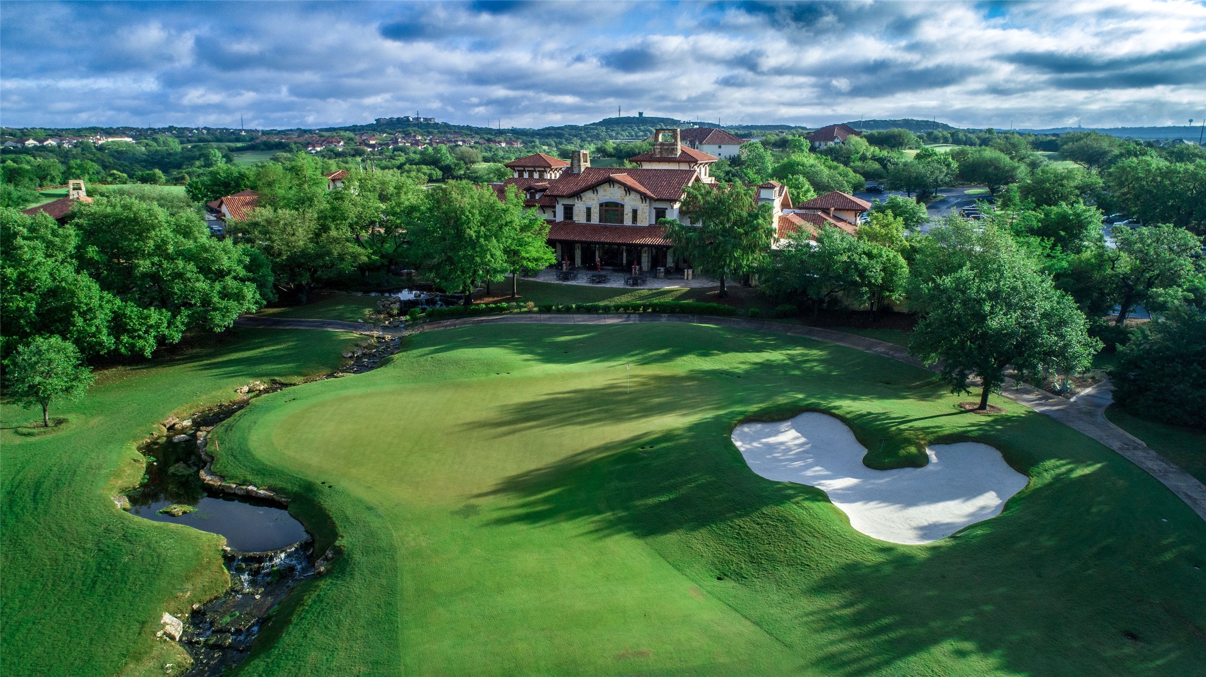 2950 Lantana Ridge Drive Austin, TX 78732 - Photo 35 of 40 a view of a garden with plants and large trees