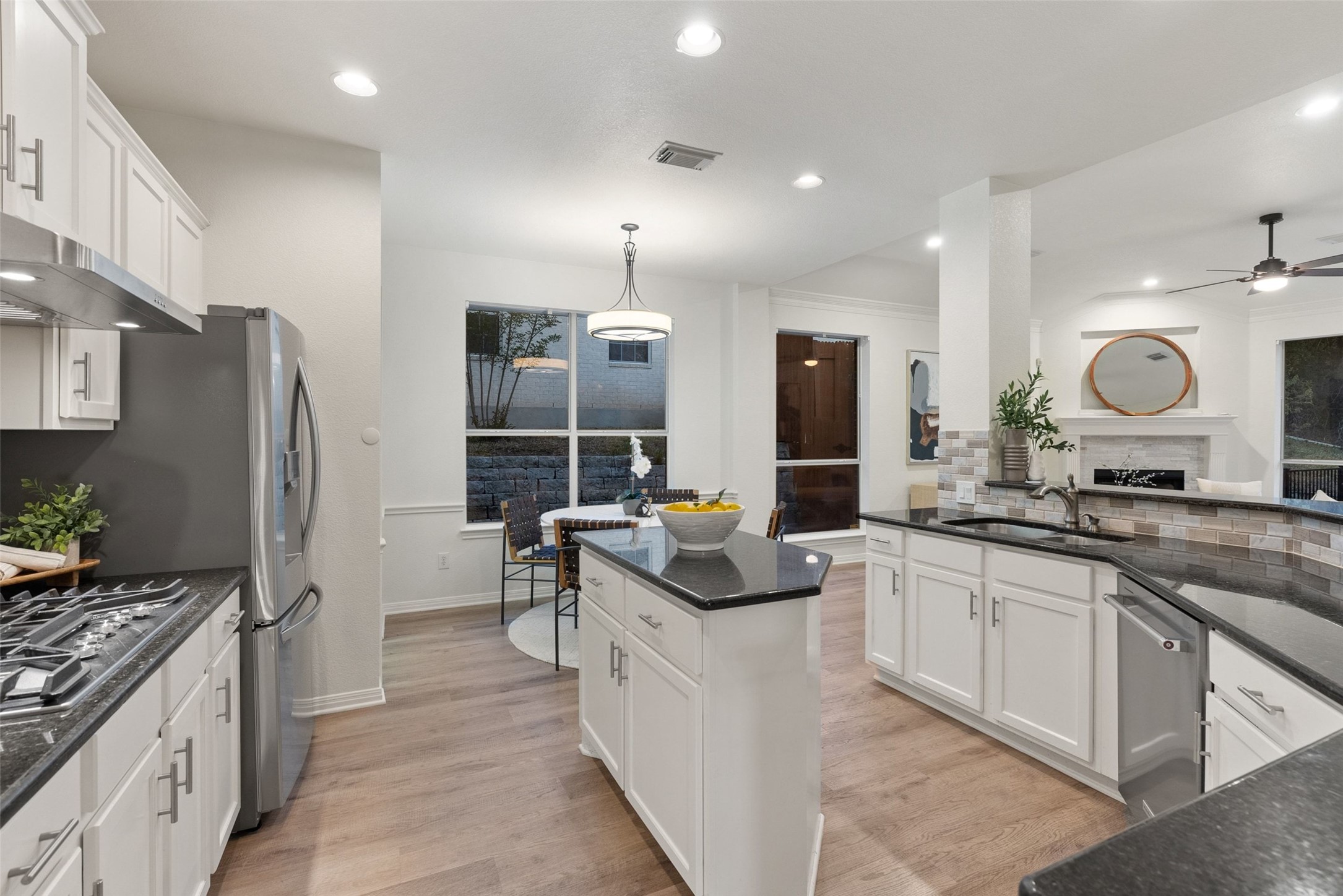 2950 Lantana Ridge Drive Austin, TX 78732 - Photo 5 of 40 a kitchen with white cabinets and sink