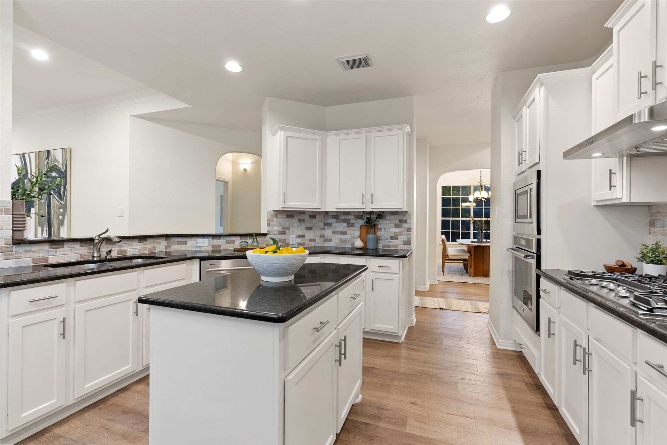 2950 Lantana Ridge Drive Austin, TX 78732 - Photo 6 of 40 a kitchen with white cabinets and appliances