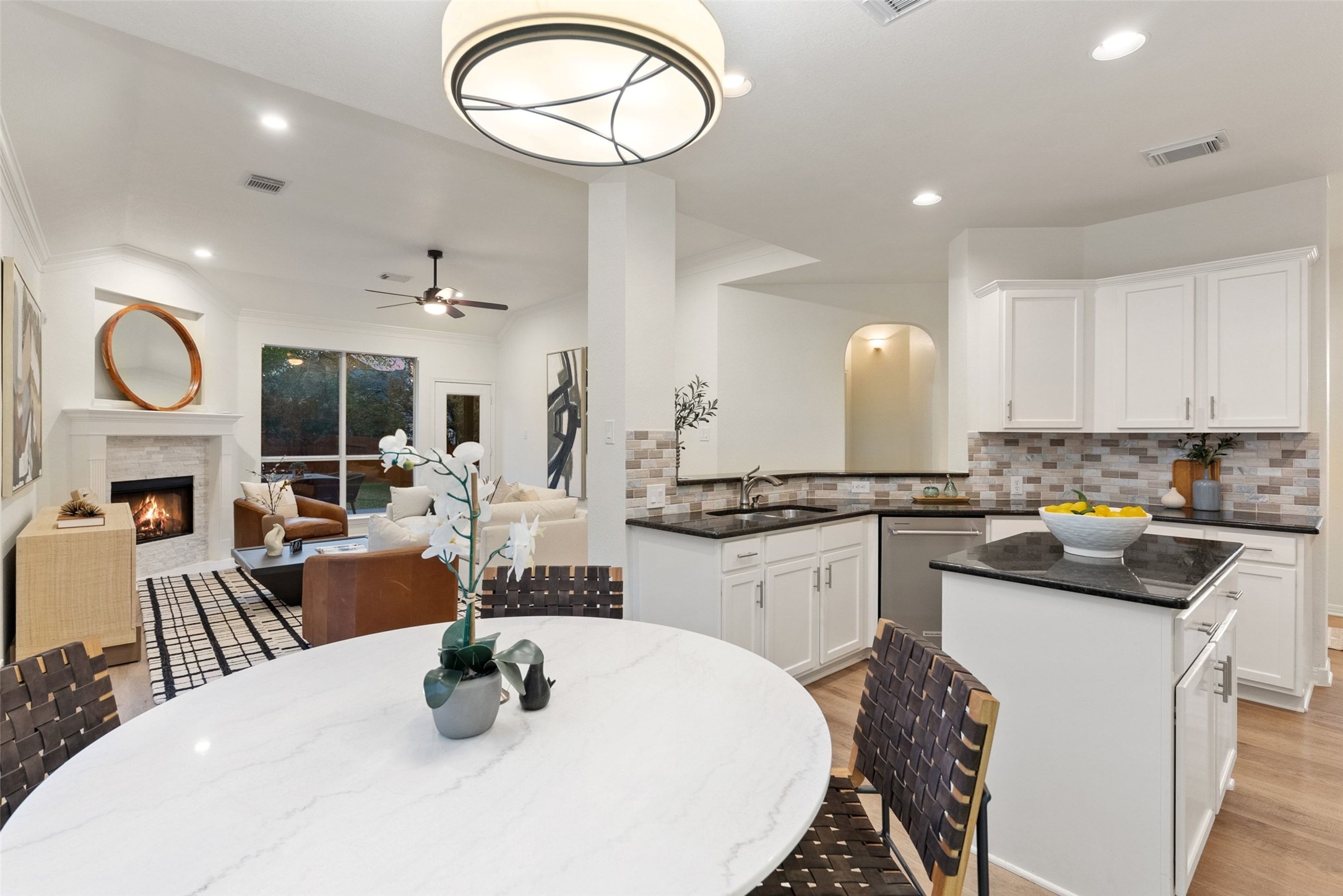 2950 Lantana Ridge Drive Austin, TX 78732 - Photo 8 of 40 a kitchen with sink a table and chairs in it