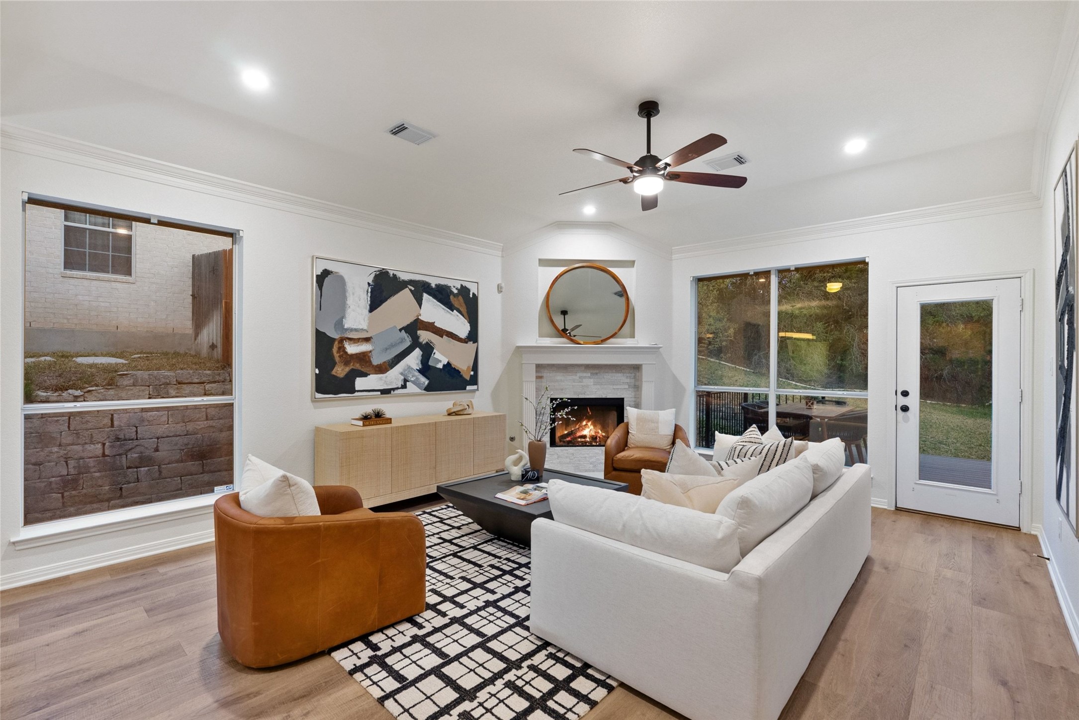2950 Lantana Ridge Drive Austin, TX 78732 - Photo 9 of 40 a living room with furniture a fireplace and a floor to ceiling window