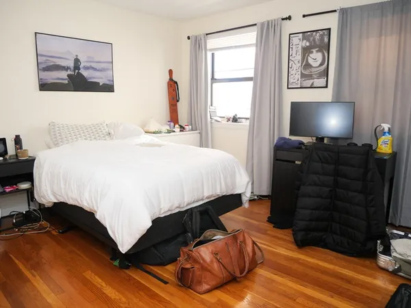 a bedroom with a bed and a dresser