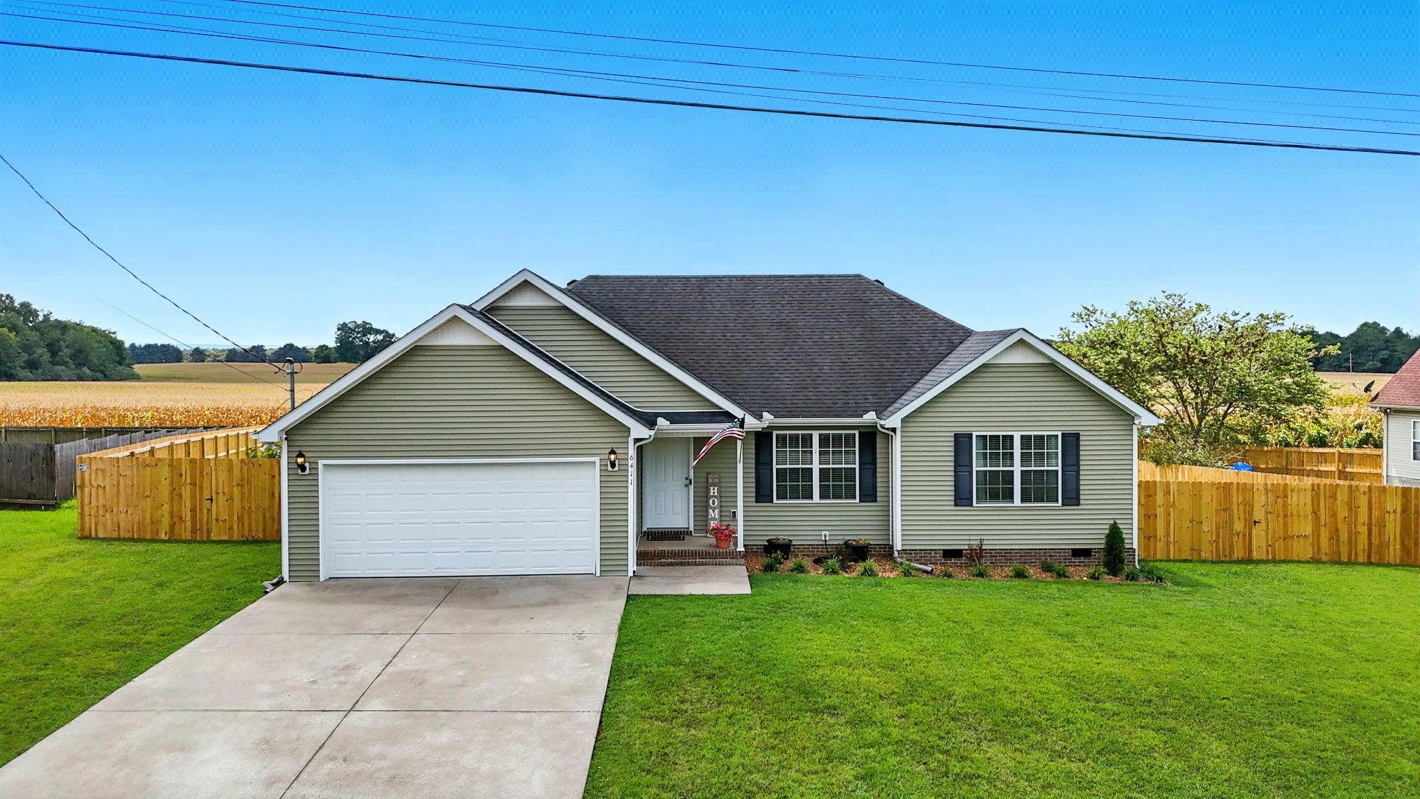 6411 Spring Creek Road Tullahoma, TN 37388 - Photo 1 of 57 a front view of a house with a yard and garage