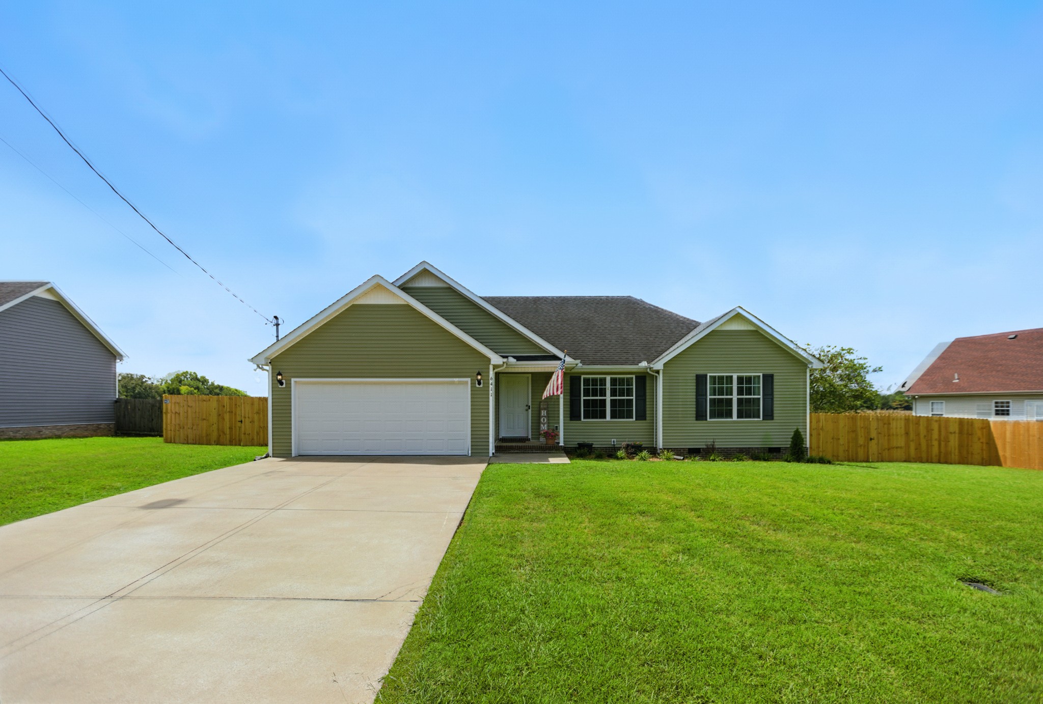 6411 Spring Creek Road Tullahoma, TN 37388 - Photo 2 of 57 a front view of a house with a yard and garage