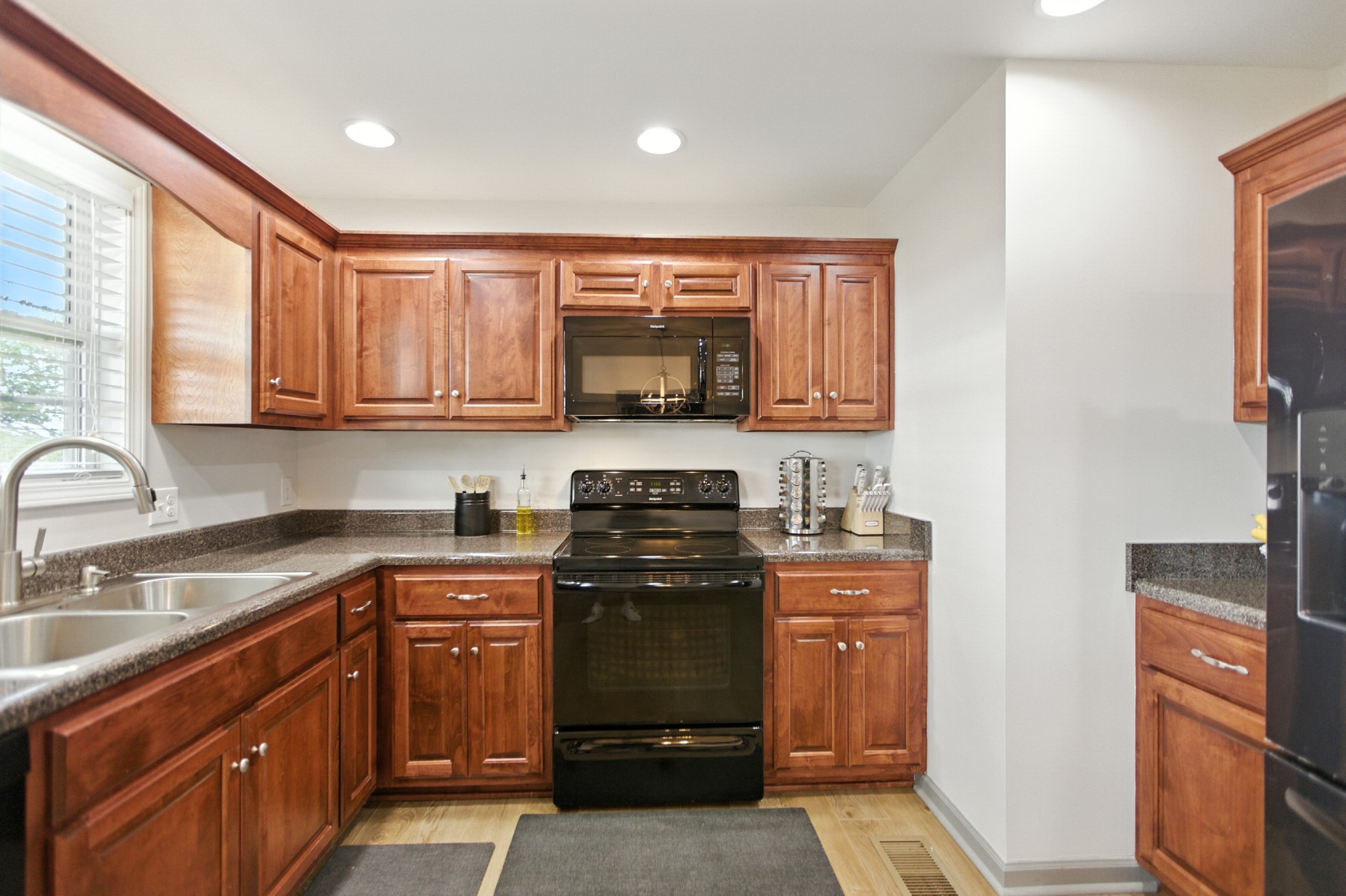 6411 Spring Creek Road Tullahoma, TN 37388 - Photo 21 of 57 a kitchen with stainless steel appliances granite countertop a stove sink and cabinets