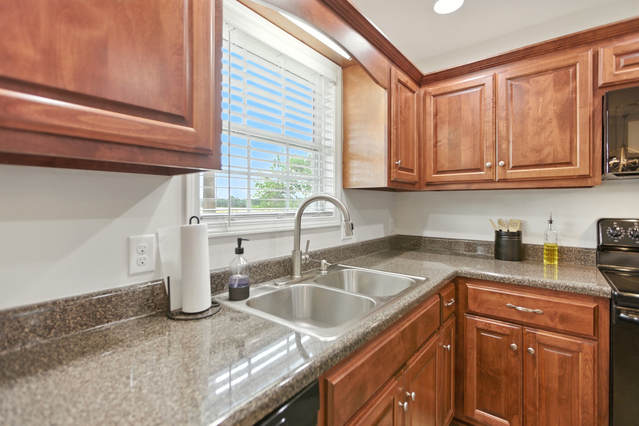 6411 Spring Creek Road Tullahoma, TN 37388 - Photo 22 of 57 a kitchen with granite countertop a sink and cabinets